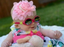 Infant with sunglasses and hair bow
