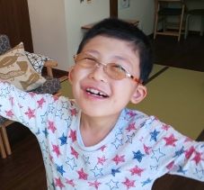 Boy with glasses smiling
