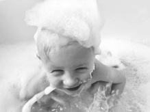 Infant smiling in bath tub