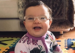 Young child smiling in glasses