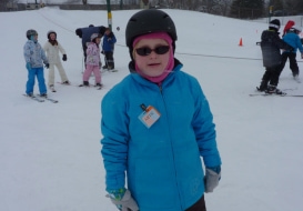 Girl smiling on skis