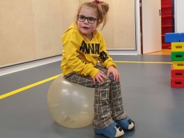 Young girl sitting on large ball