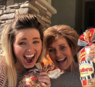 Image of 2 people smiling with popcorn