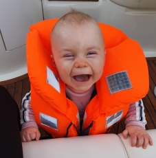 Image of smiling baby in life jacket
