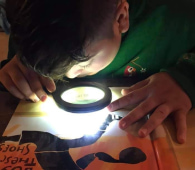 Child with magnifying glass
